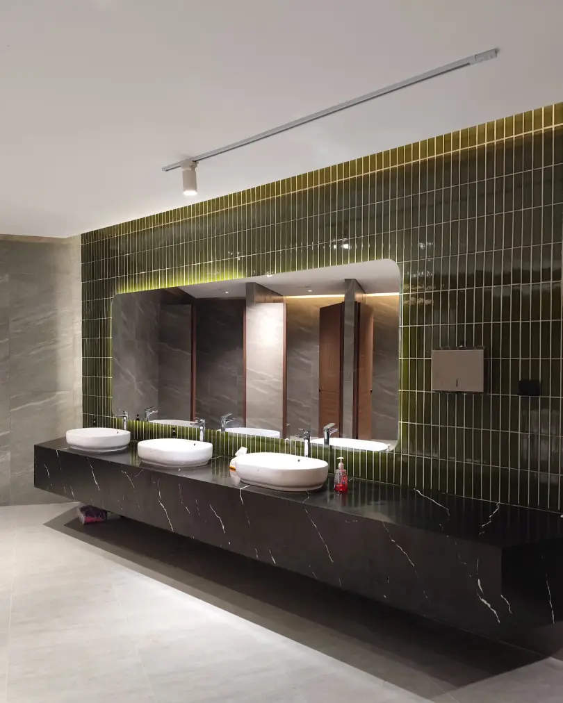 Green-tiled bathroom vanity